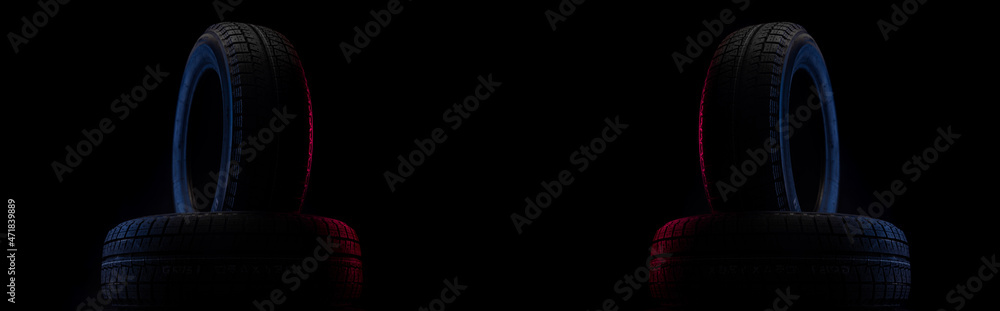 two tires with tread for driving on snow and ice on a black background two tires with tread for driving on snow and ice on a black background
