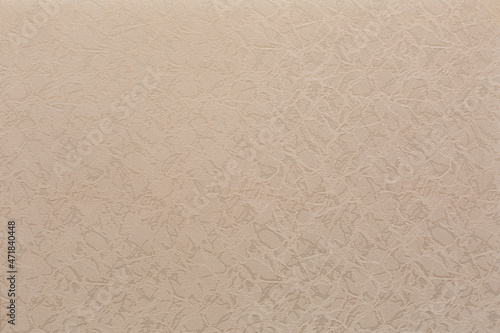 textured abstract embroidery ornament on fabric beige