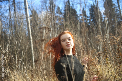 Young woman in the autumn forest girl pretty cute face female smile field red hair beauty one person model portrait girls outdoor beautiful lady © Elen Zemskovich