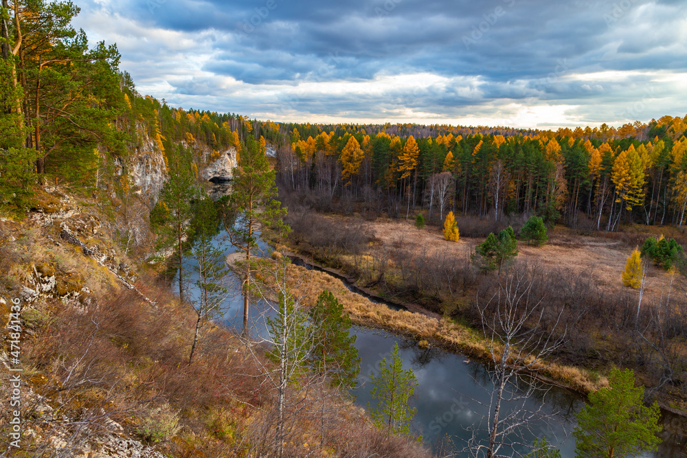 Autumn nature with a river of pines and rocks, yellow foliage against the background of the evening sky. Russia National Park Autumn nature with a river of pines and rocks, yellow foliage against the background of the evening sky. Russia National Park