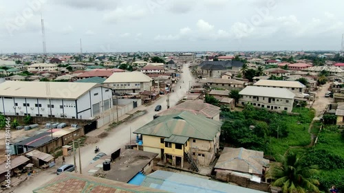Mowe Town in Nigeria's Ogun State - view of a dirt road and a thriving West African city - ascending aerial view photo