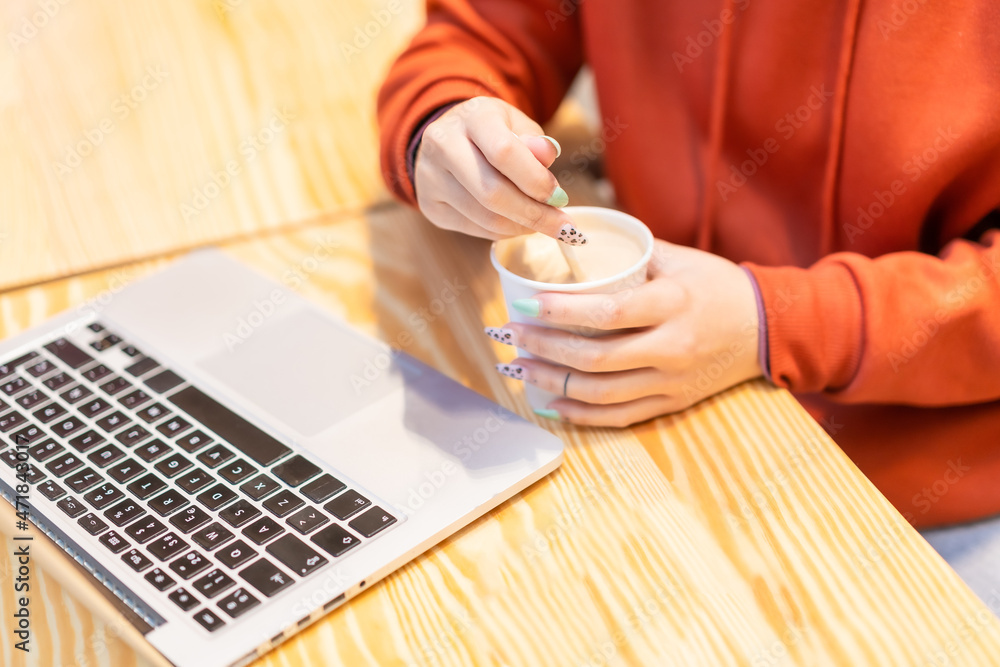 Fototapeta premium Alternative unrecognizable person with a coffee surfing the internet on the computer