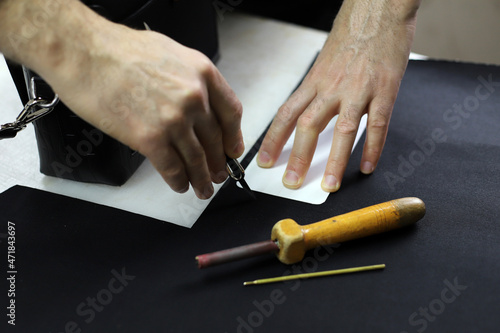 Designer creates a model with tools on the table. Fixing a pattern on the fabric. Tailor is making a bag. Designer creates a model with tools on the table. Top view, flat lay.