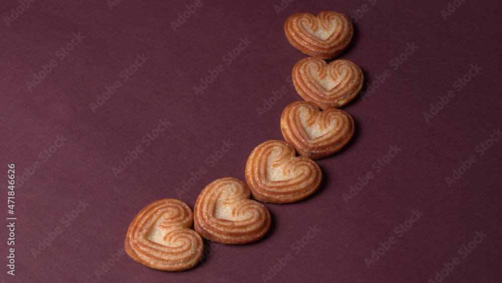 Delicious homemade heart shaped cookie on a color background. Top View. Place for text.
Delicious homemade heart shaped cookie on a color background. Top View. Place for text.