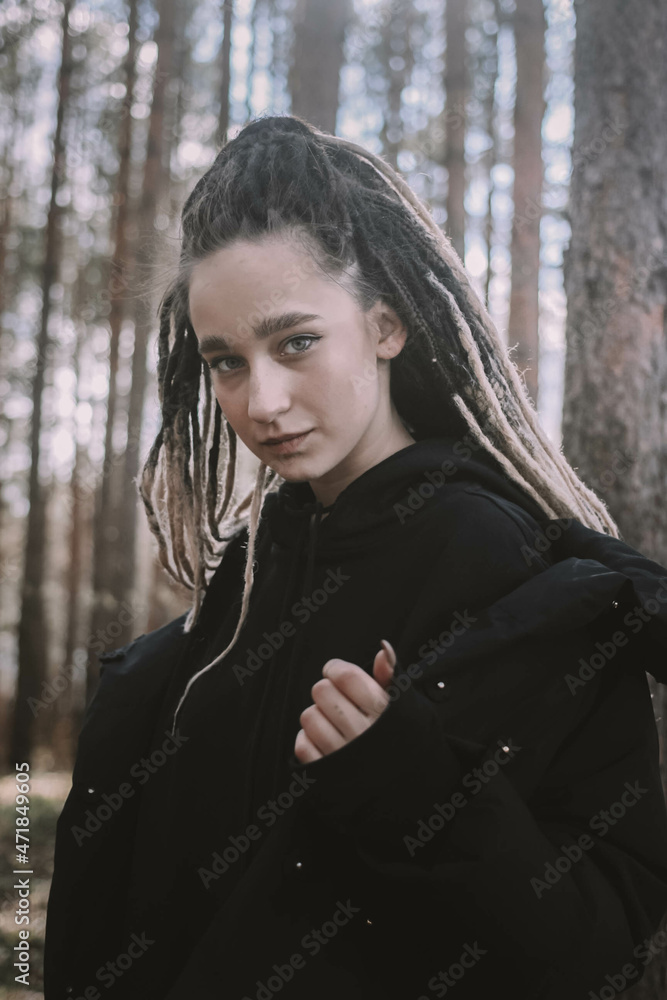 girl with dreadlocks in the forest girl with dreadlocks in the forest