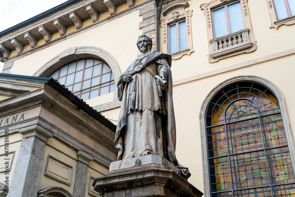 Statue of the cardinal and Archbishop of Milan Federico Borromeo in front of the the Biblioteca Ambrosiana, historic library housing the Ambrosiana art gallery, in Milan, Lombardia region, Italy