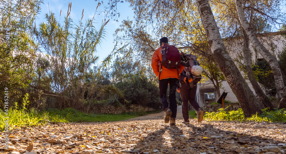 Fototapeta premium Hikers walk with a backpack with climbing equipment.