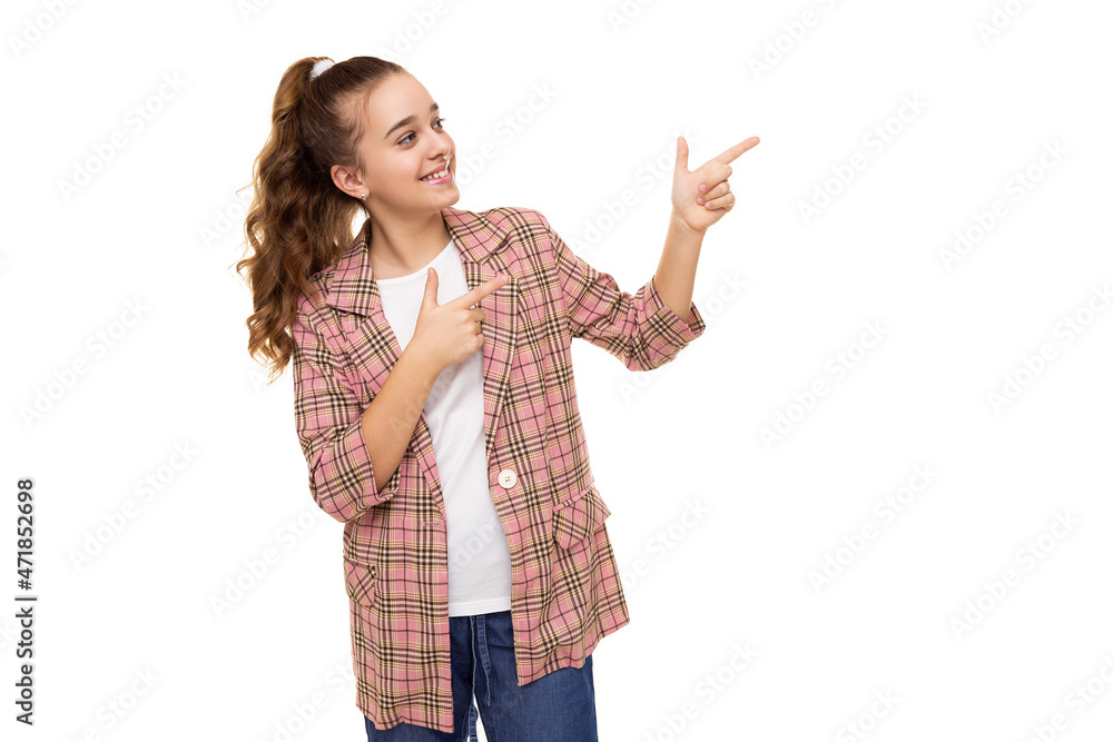 Photo of beautiful cute adorable smiling brunette teenage girl with ponytail in stylish plaid jacket and blue jeans isolated on white background shows fingers on free space for text Photo of beautiful cute adorable smiling brunette teenage girl with ponytail in stylish plaid jacket and blue jeans isolated on white background shows fingers on free space for text