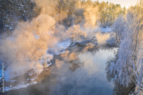 Incredible winter landscape on the river with snow, frost, fog. Morning winter landscape