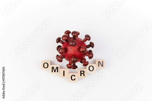 Model of corona virus with the word omicron as symbol for the new covid-19 mutant virus from south africa