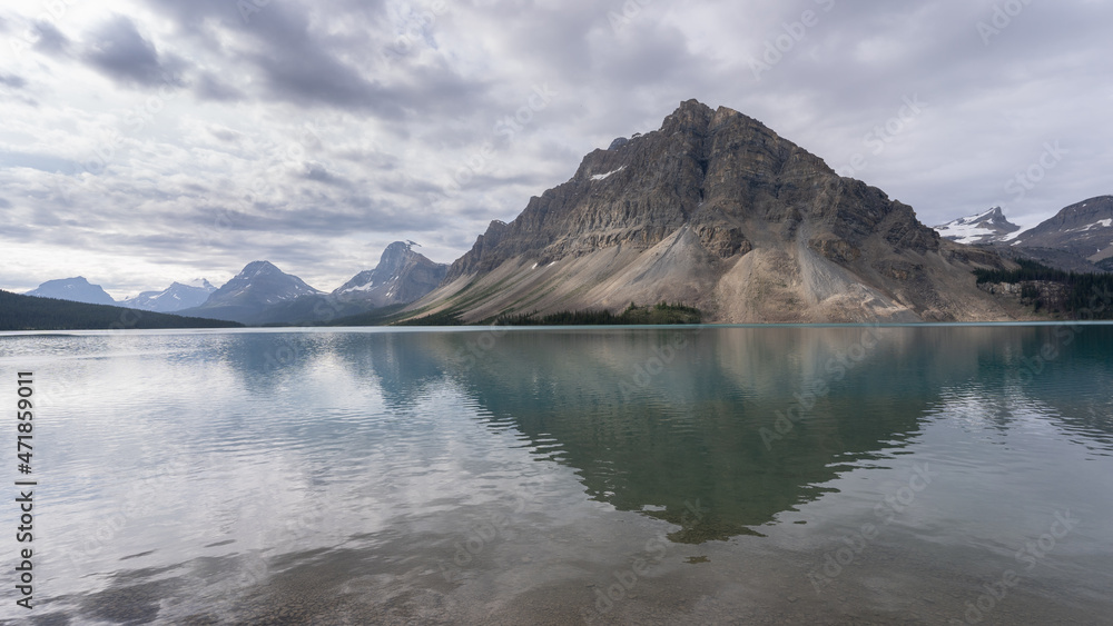View on alpine glacier lake with mountain reflecting on its surface, Canadian Rockies, Canada