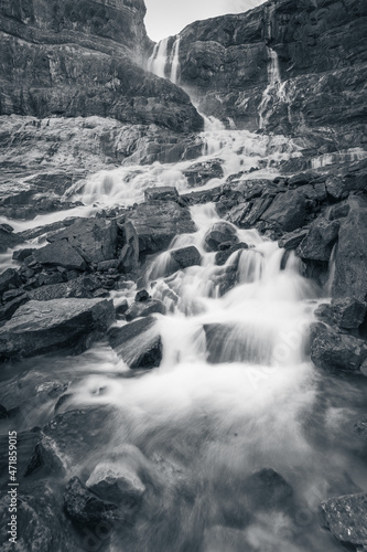 Black and white vertical long shutter shot of cascading waterfall from Canadian Rockies  Canada