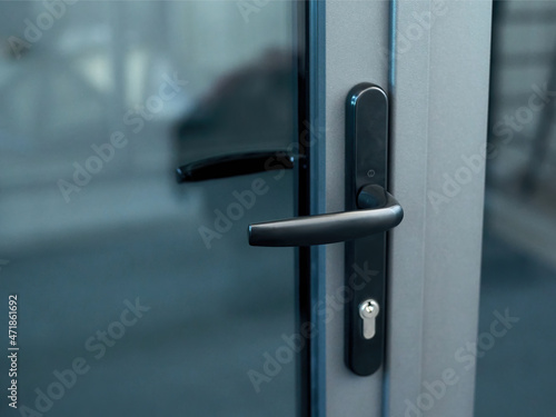 stylish door handle with lock on the glass door. photo