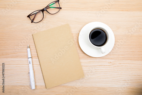 open notepad  cup of coffee  pen  glasses on wooden background spiral notebook on table Business  planning  education  morning life working from home concept Top view Flat lay Mock up- Image