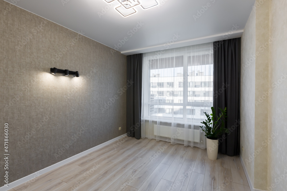 Fototapeta premium Small room after renovation, and unfurnished, interior with a large window