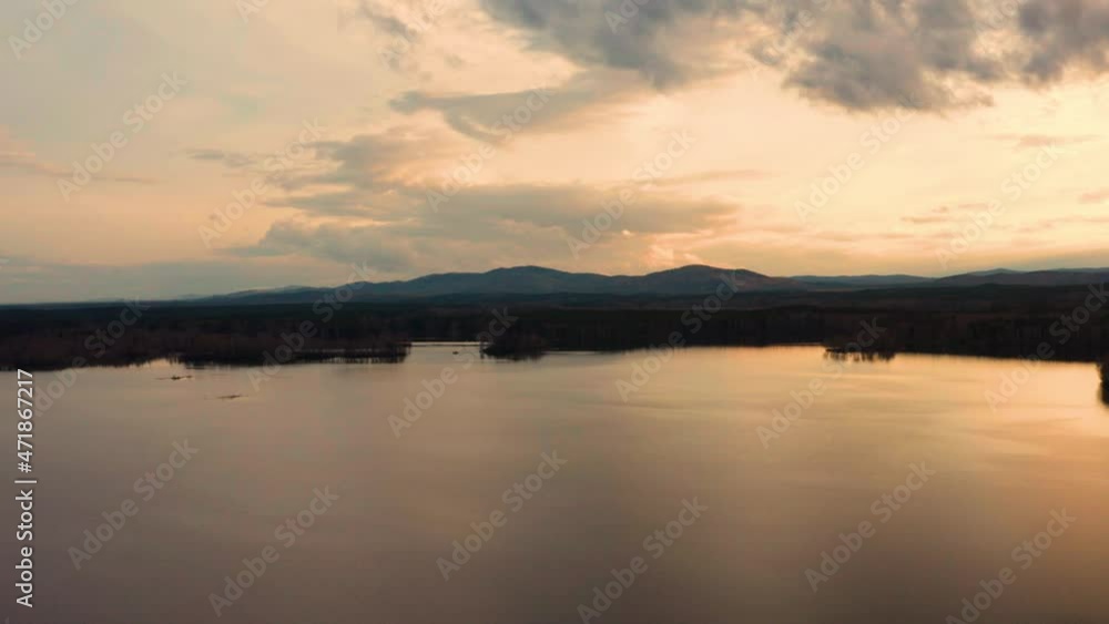 Aerial view of the natural landscape forest on the lake shore at sunset Aerial view of the natural landscape forest on the lake shore at sunset