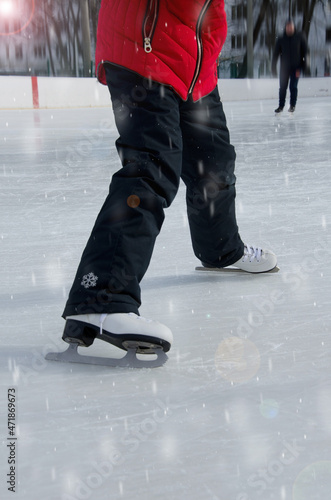 The child learns to skate independently. Winter Kids Games Selective, Soft Focus, Bokeh and Snow
