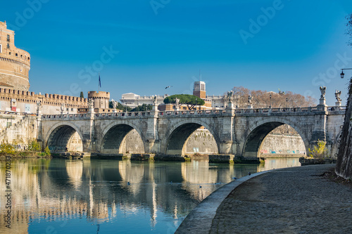 A view of Ponte Sant'Angelo (Bridge of Hadrian) on Tiber river in front of Castel Sant'Angelo (Castle of the Holy Angel)  in Parco Adriano, Rome, Italy © Baharlou
