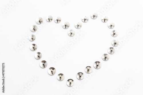 Heart Shape Heap of Metal Pushpin or Drawing Pin isolated on white
