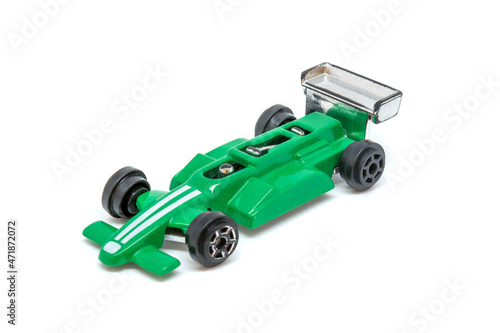 Photo of green toy model car isolated on white background