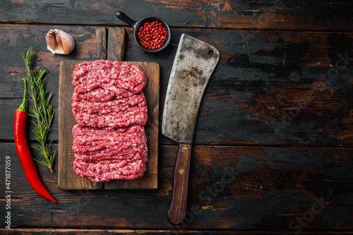 Minced meat, on old dark  wooden table background, top view flat lay  with copy space for text photo