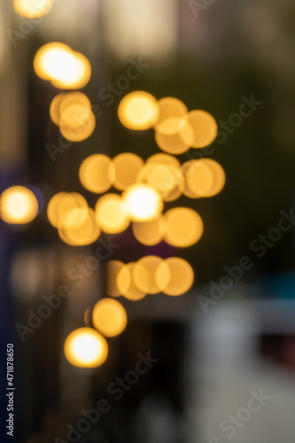 Bokeh of bright yellow light bulbs at night on the street. © Prikhodko