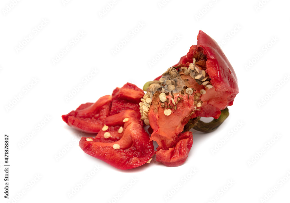 Pieces of broken red bell pepper on a white background. Pieces of broken red bell pepper on a white background.