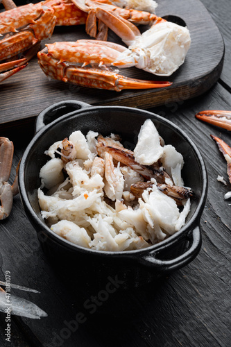 Mixed brown white crabmeat boiled set, on black wooden table background
