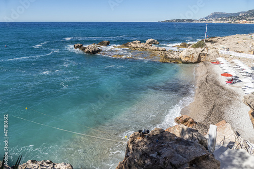 The beautiful Balzi Rossi beach in Ventimiglia with Menton in background photo