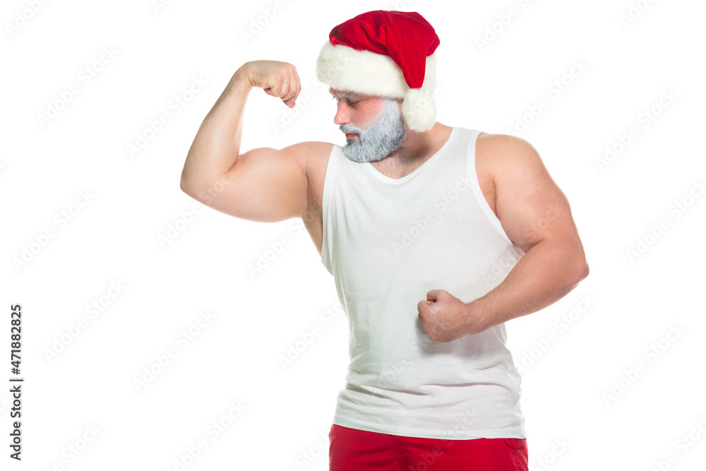 Christmas. Portrait of muscular sexy strong athlete in Santa Claus costume with grey beard posing showing his biceps isolated on white background