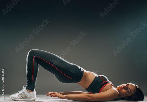 Portrait of healthy slim athletic woman doing gymnastics