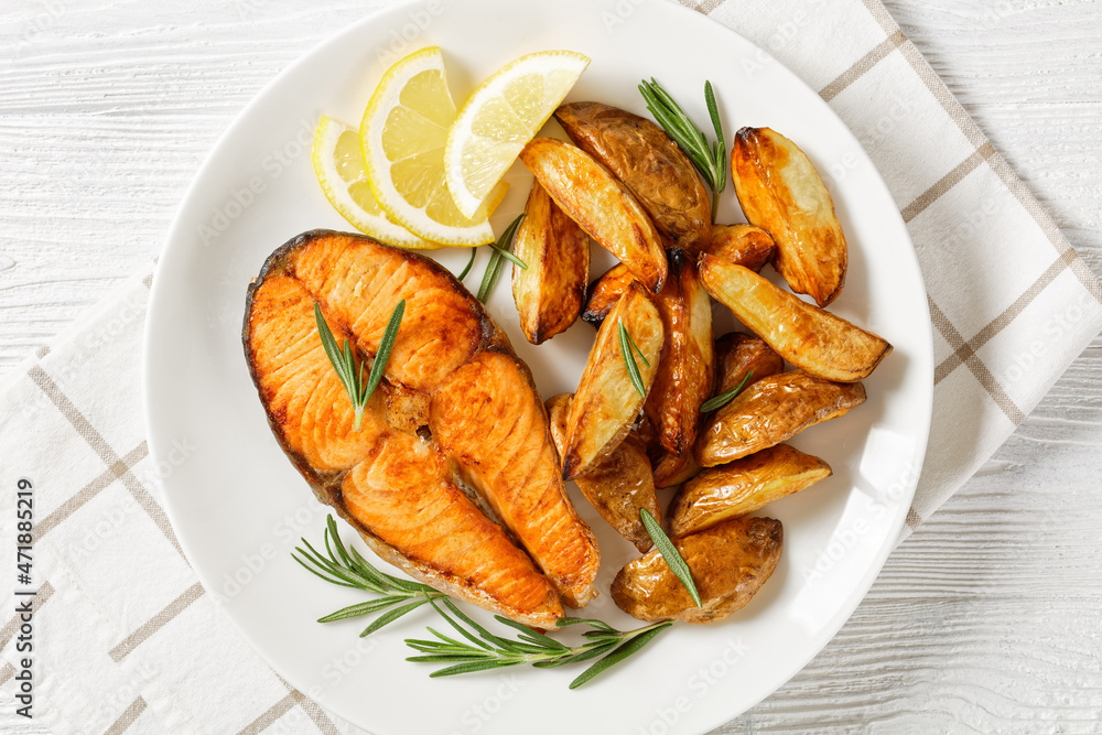 baked salmon steak and potatoes on a plate baked salmon steak and potatoes on a plate