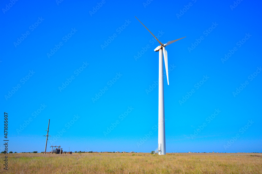Wind power generation. Wind turbine in a field.
