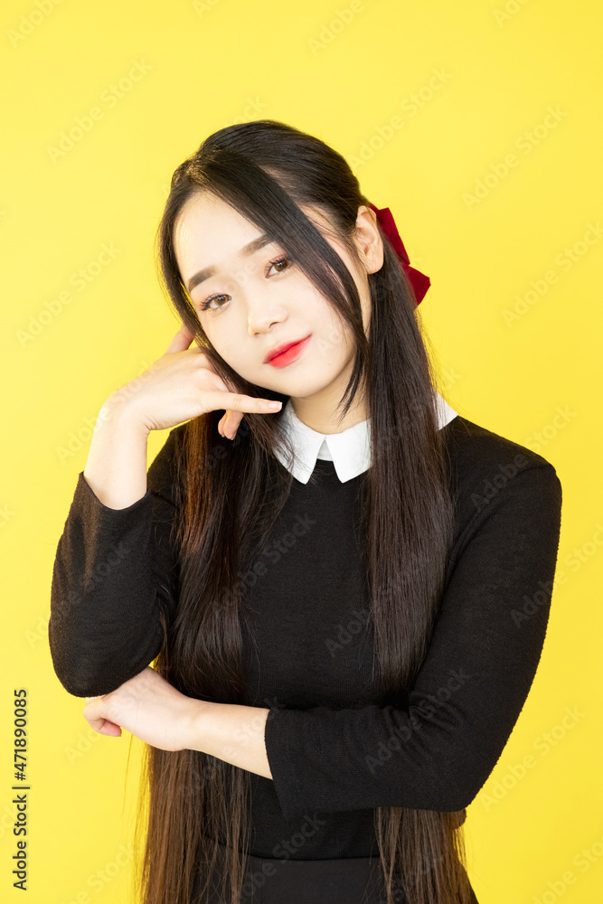 Phone gesture. Call me. Mobile communication. Appointment contact. Cheerful sweet woman showing cell hand sign isolated on yellow background. Phone gesture. Call me. Mobile communication. Appointment contact. Cheerful sweet woman showing cell hand sign isolated on yellow background.