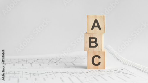 abc - letters on wooden cubes . concept on cubes and diagrams on a gray background. Business as usual concept imag.