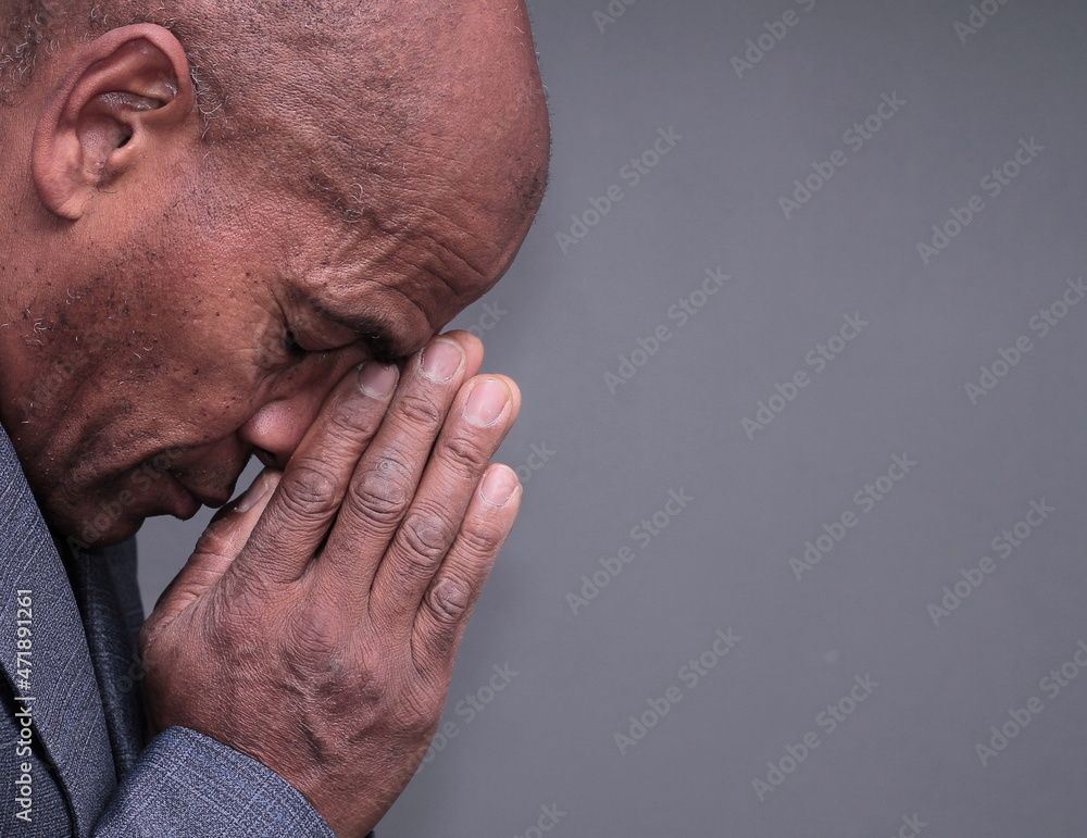 man praying to god with hands together stock photo man praying to god with hands together stock photo