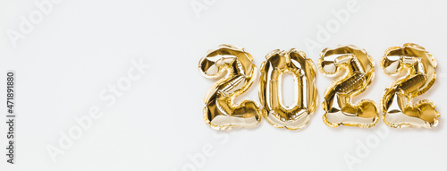 Banner New Year 2022 Balloon Celebration Card. Gold foil helium balloon number 2022 isolated on white background. Flat lay, merry christmas, happy holidays mockup.