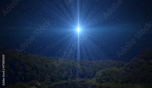 Canvas Print Star of Bethlehem, or Christmas Star over the night forest