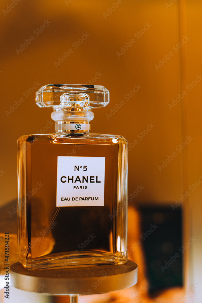 Display of glass bottle Chanel No. 5 perfume by French luxury brand Chanel  against the golden background. Famous female fragrance. Stock Photo | Adobe  Stock