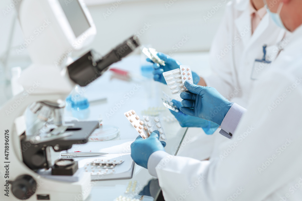 close up. scientists are testing samples of new drugs .