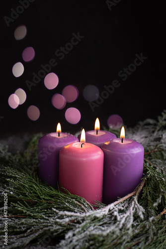 Three Christmas purple and one pink advent candle. photo
