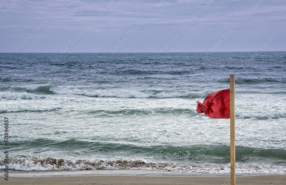 Red warning flag on Mediterranean beach