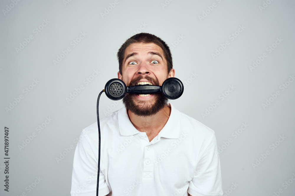 man with home phone in hands technology light background emotions man with home phone in hands technology light background emotions