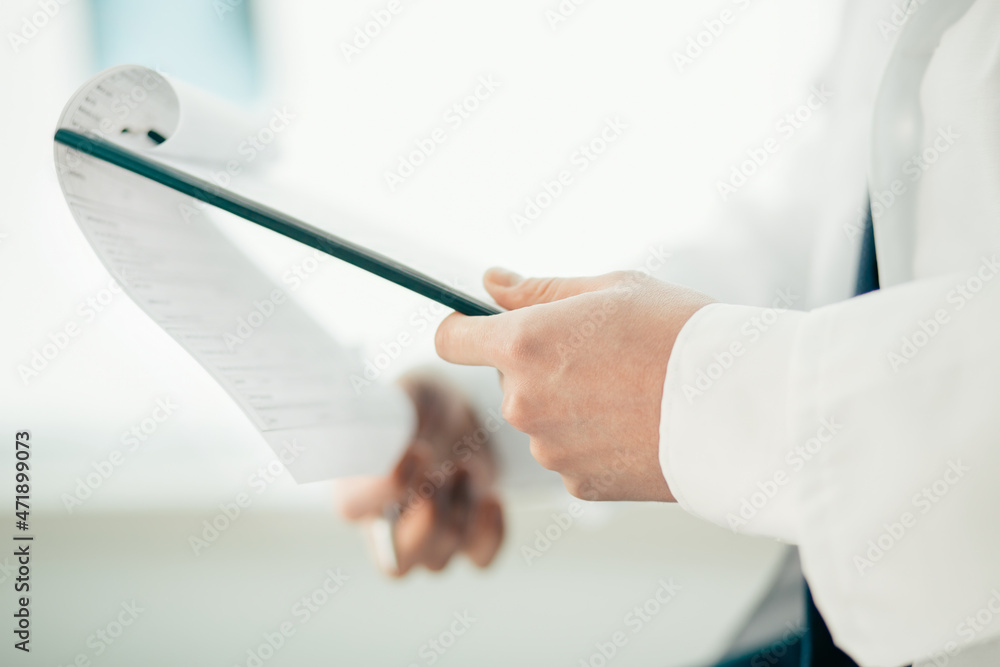close-up. doctor filling out a medical form.