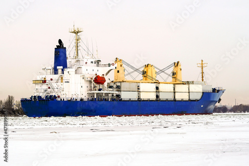 Сontainer ship moves along the forway in the ice of the Gulf of Finland. photo