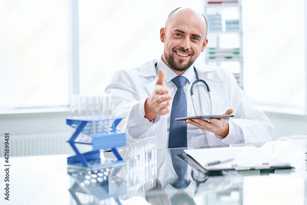 smiling young scientist works in a laboratory.