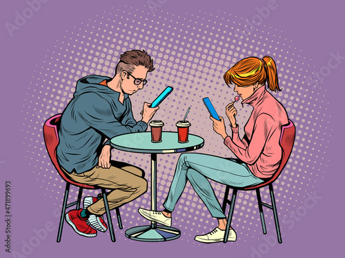 a couple on a date in a restaurant are looking at smartphones and not talking, loneliness and new technologies