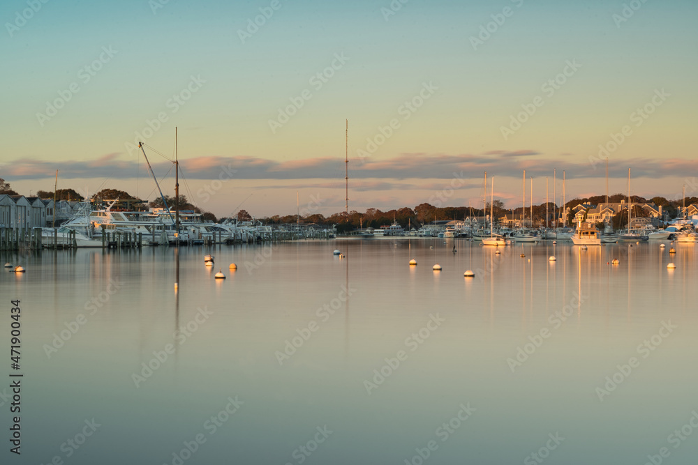 Multiple Boats, Docks, Buoys with smooth water and a clear sky