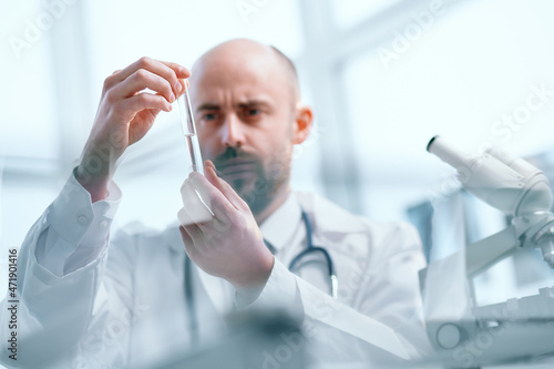 background image of a researcher examining samples of a new vaccine.