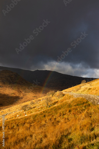 Rainbow forming over the A498 in Snowdonia National Park, Wales, United Kingdom photo